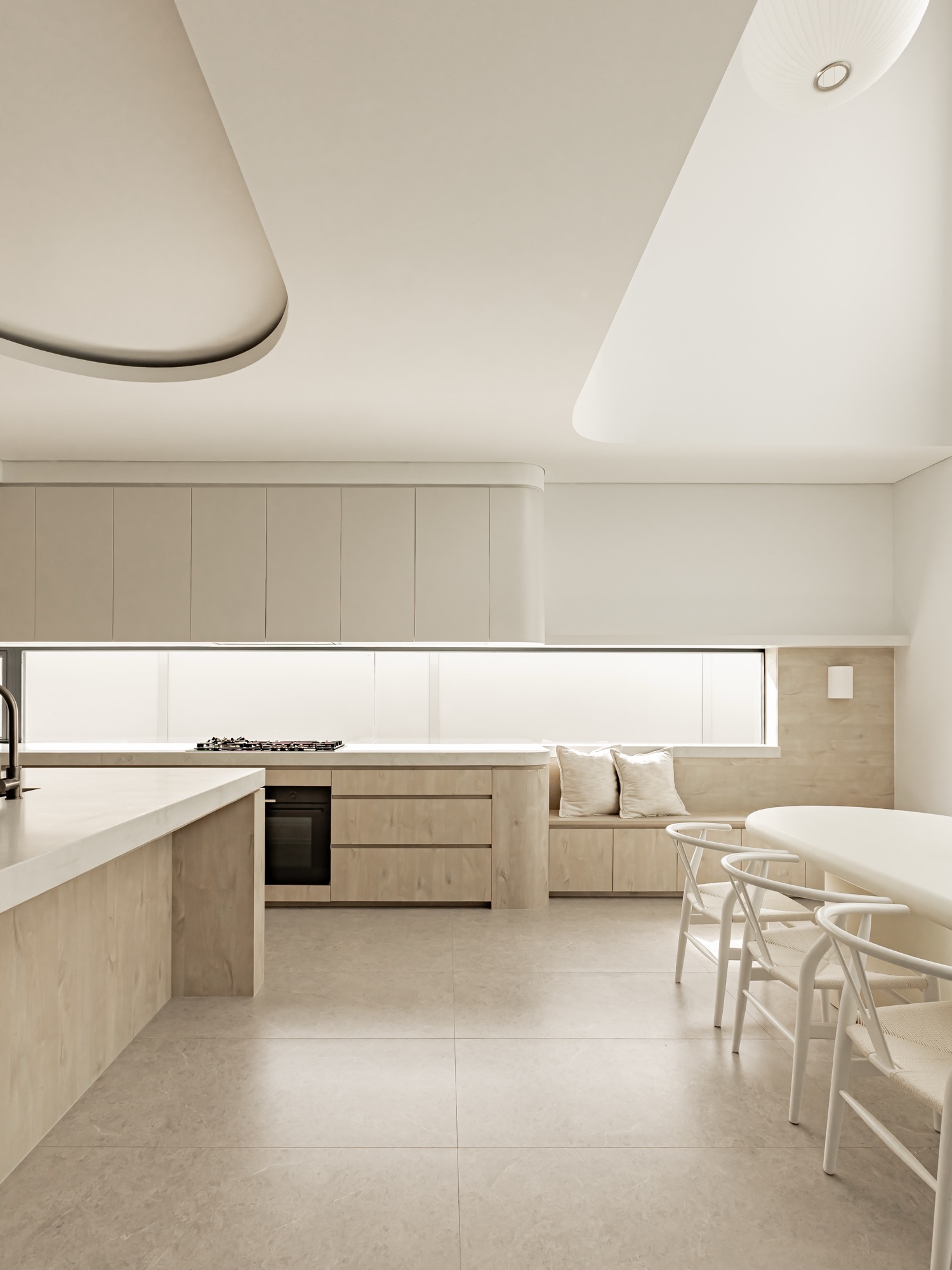 Kitchen with window seat and long ribbon window, dining beyond