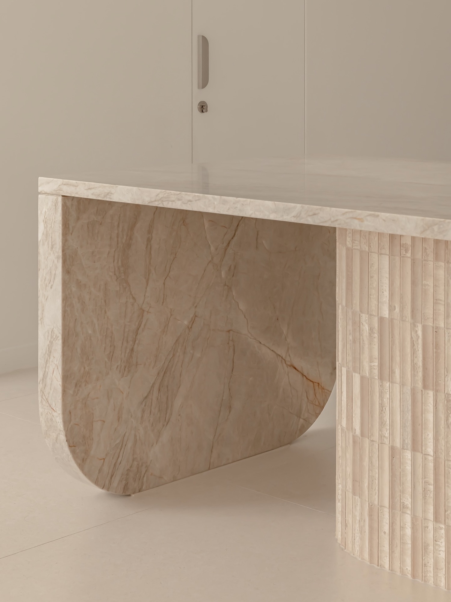 Detail of the stone bench end and fluted travertine base